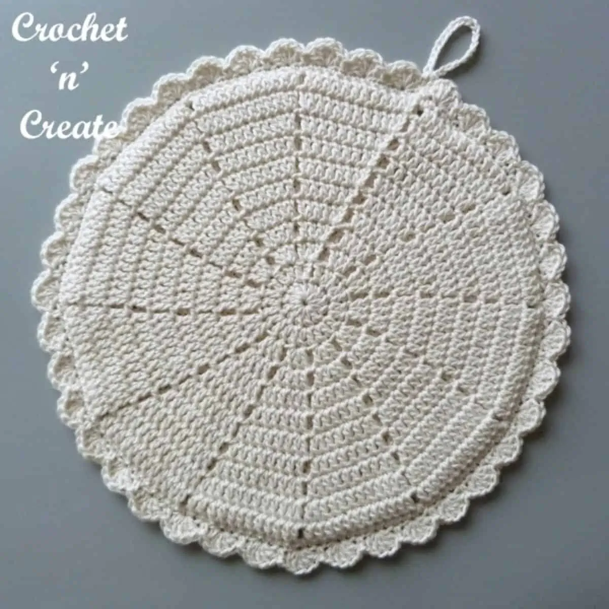 ivory colored crochet round potholder laying flat