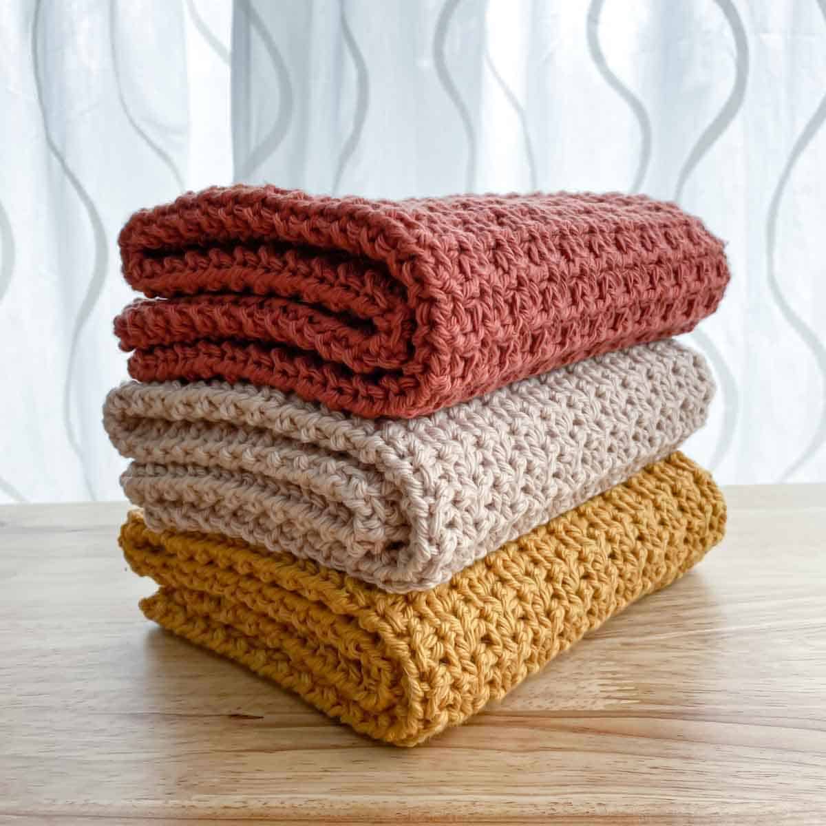 three crochet hand towels folded and stacked