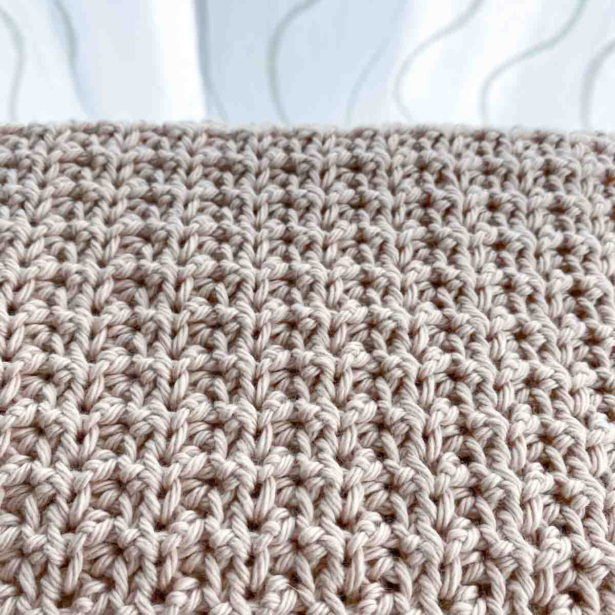 close up of the texture of crochet stitches on a hand towel