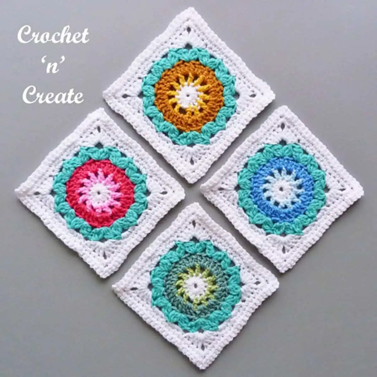 4 white granny squares with colorful centers