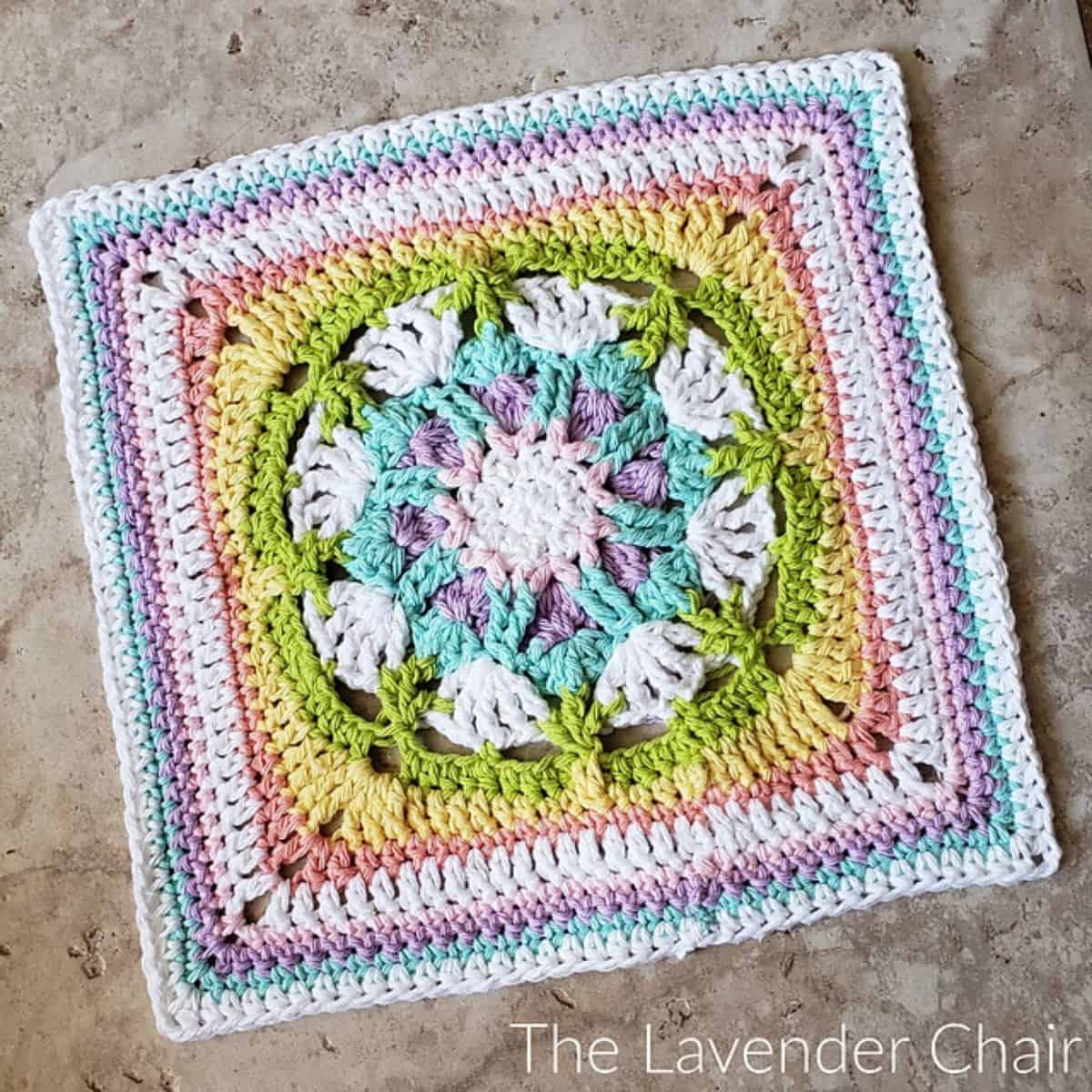 unusual crochet granny square that is colorful and has a subtle flower motif
