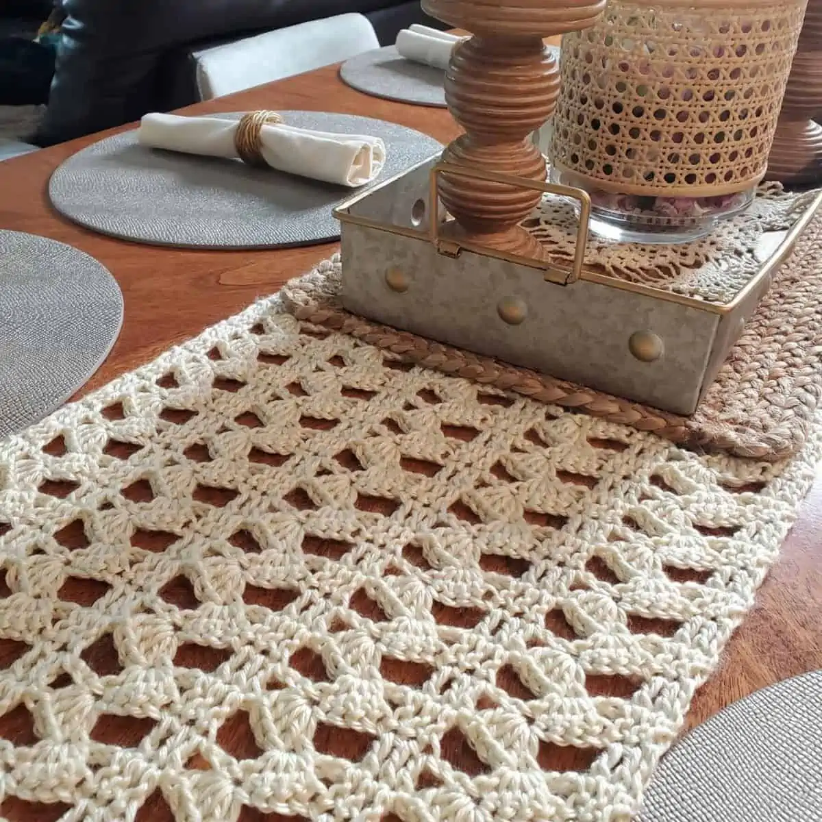 crochet runner with a zigzag pattern and a centerpiece with place settings