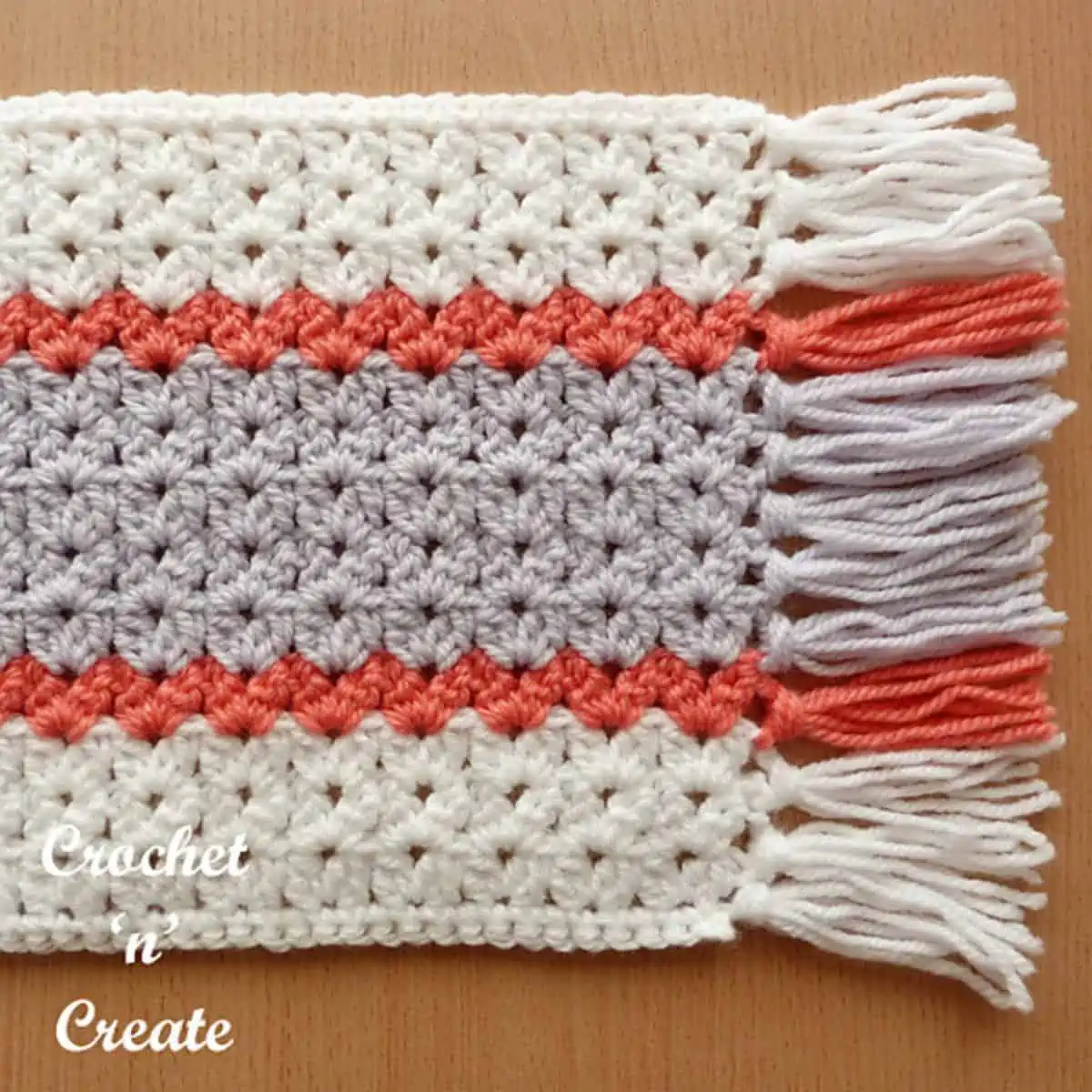 striped crochet fabric with open stitch work and fringe