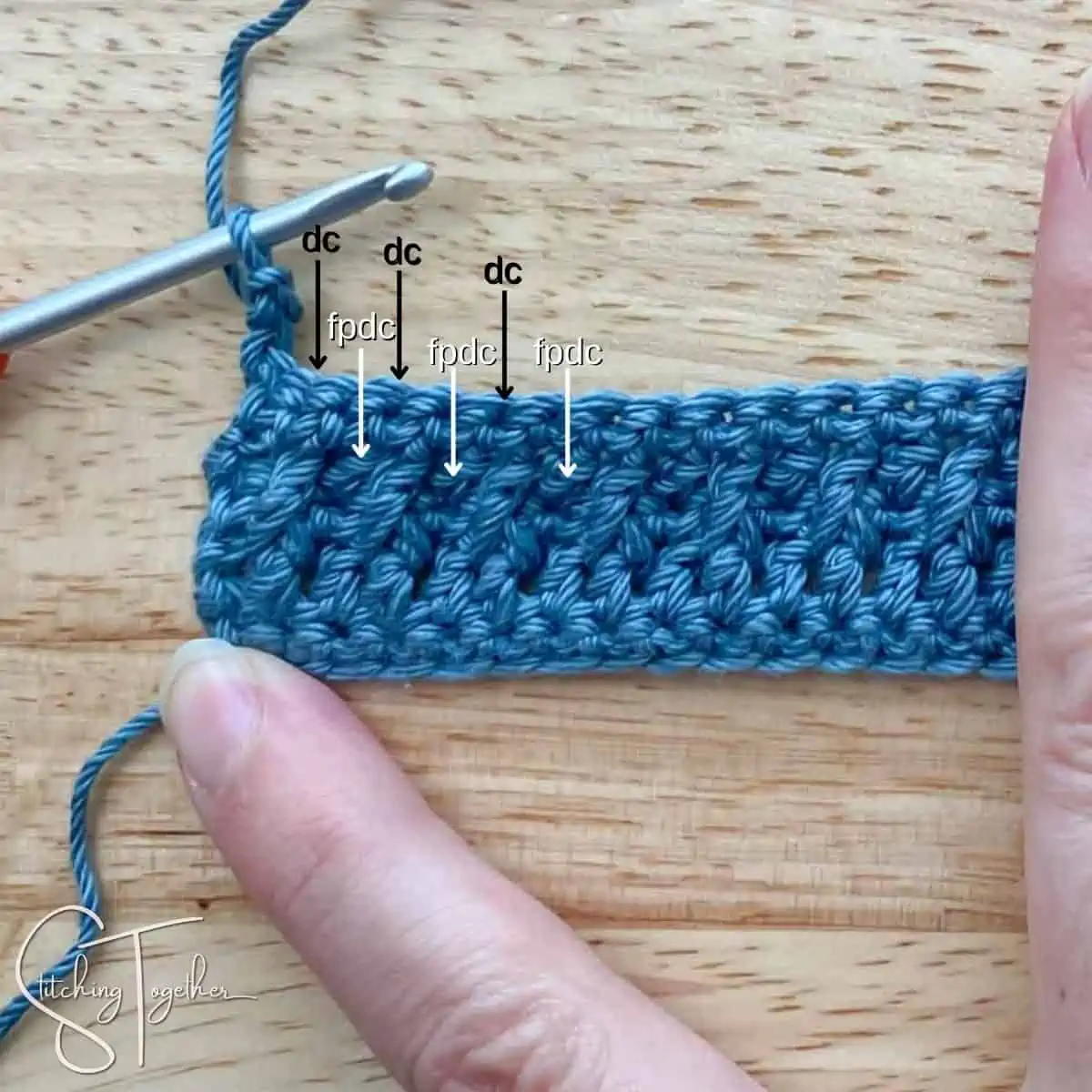 left handed crochet swatch with arrows showing where to put the dc and fpdc stitches