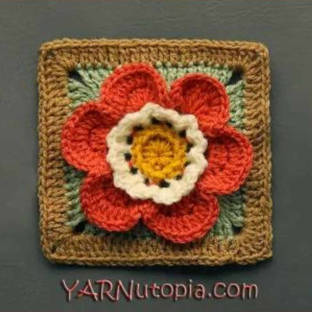 crochet granny square in fall colors with a floral motif