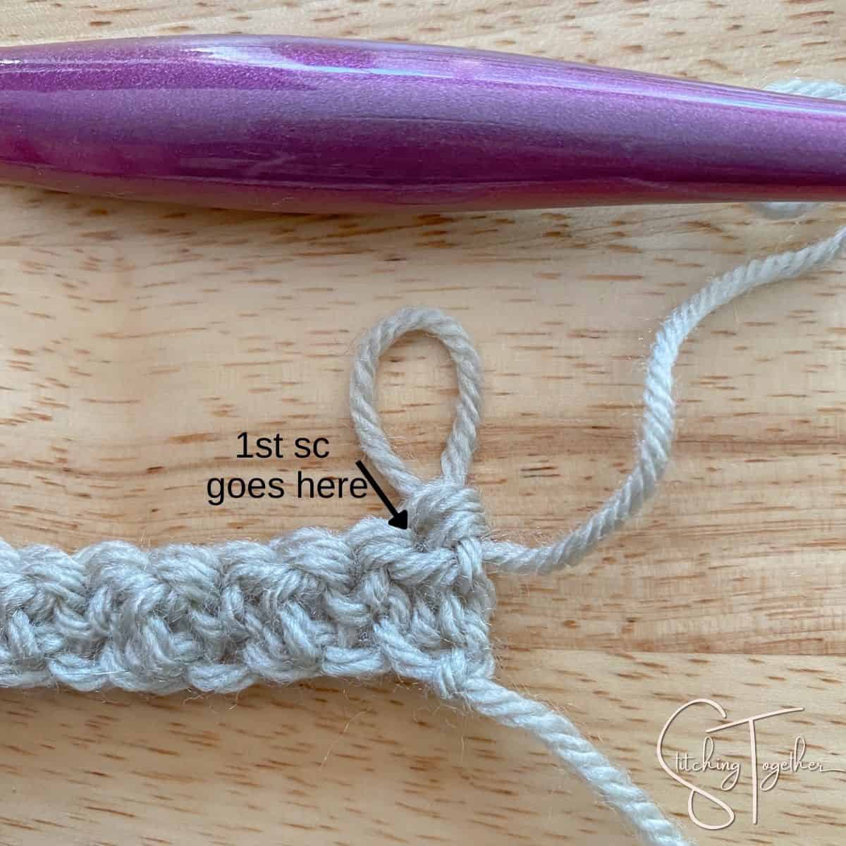 starting row 2 of the lemon peel stitch with an arrow showing where to place the first stitch