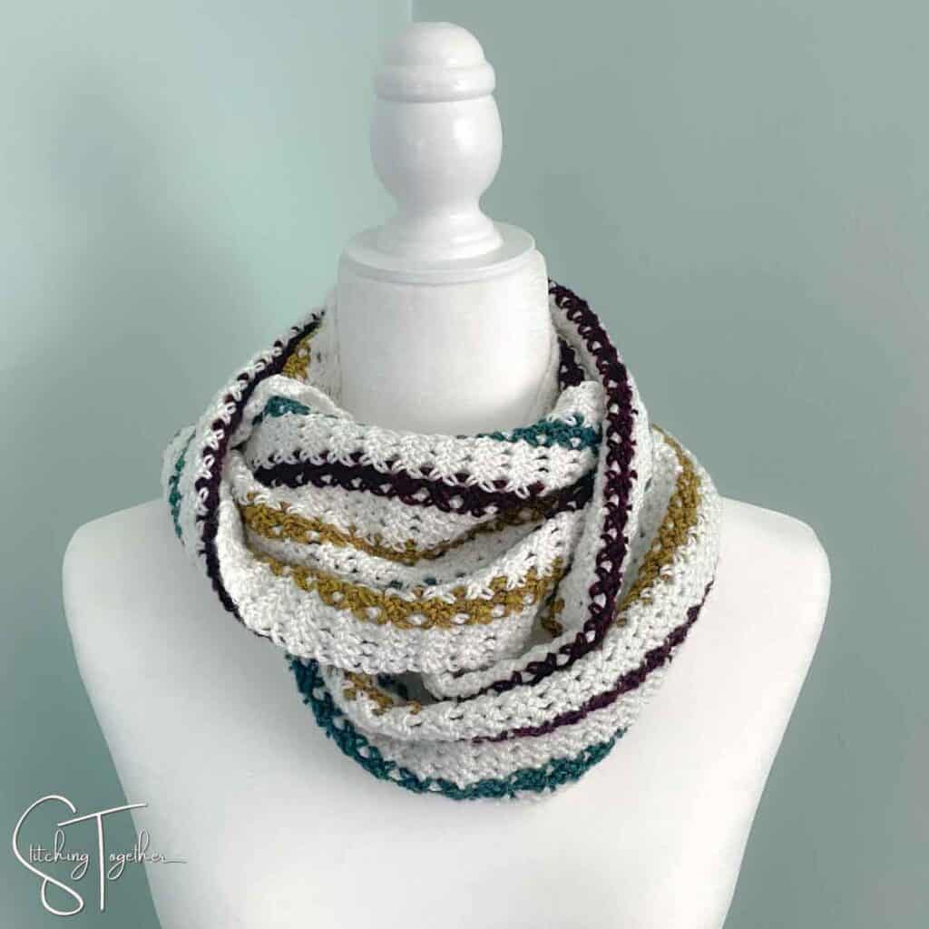 striped crochet infinity scarf wrapped around the neck of a mannequin