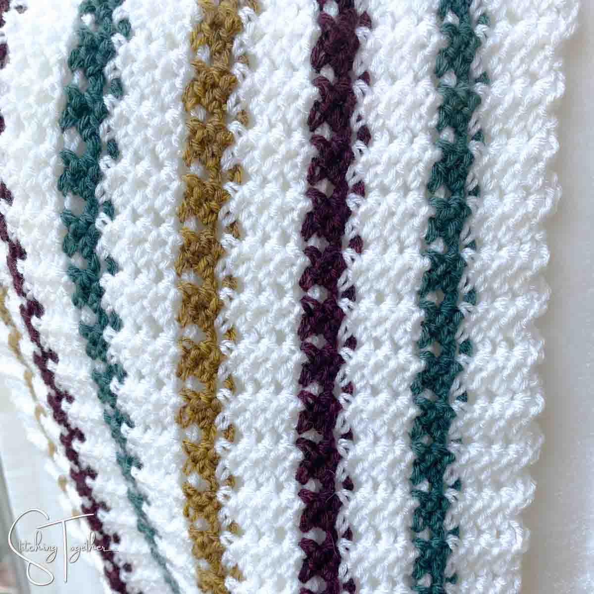 close up of striped lacy crochet stitches