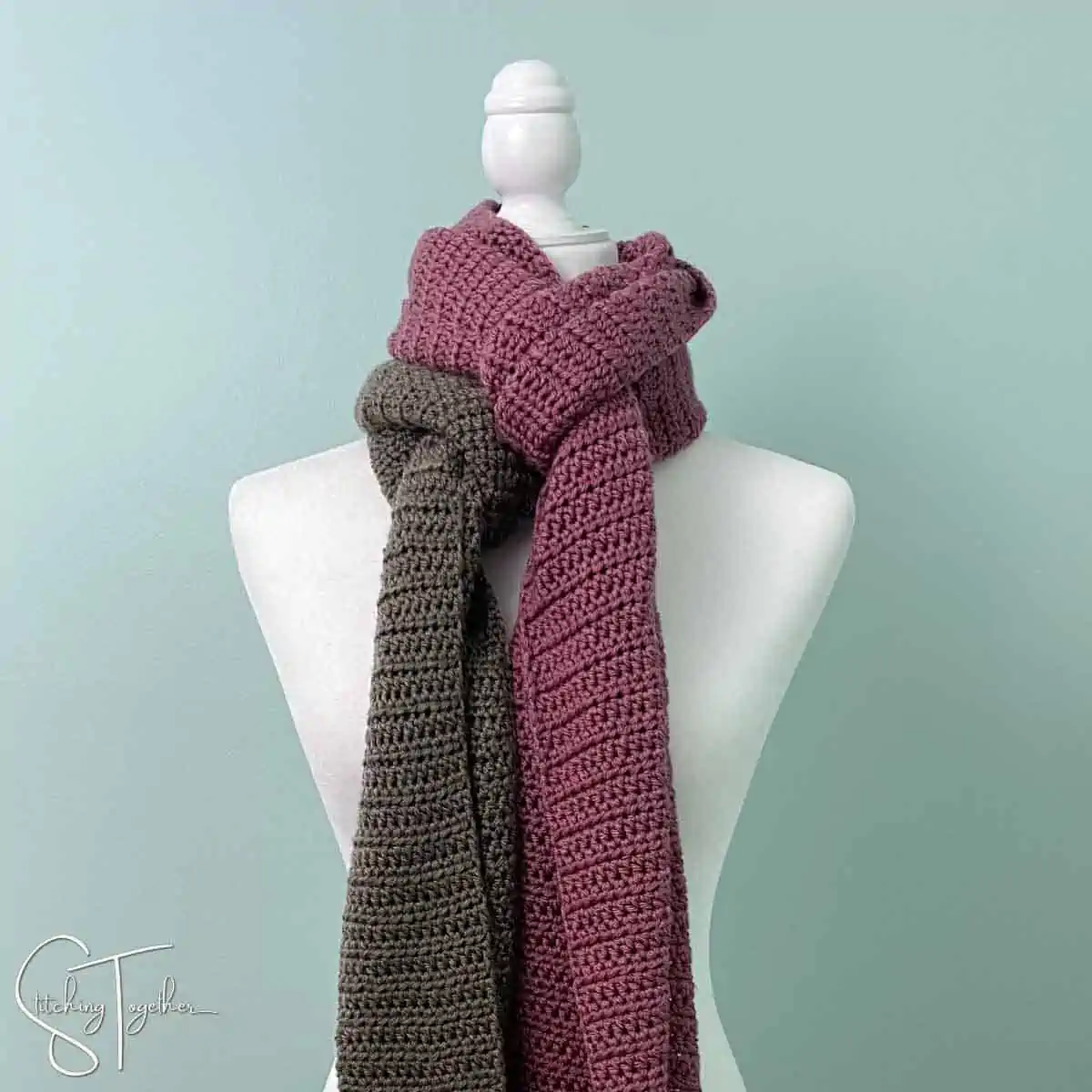 two different colored crochet scarves around the neck of a mannequin