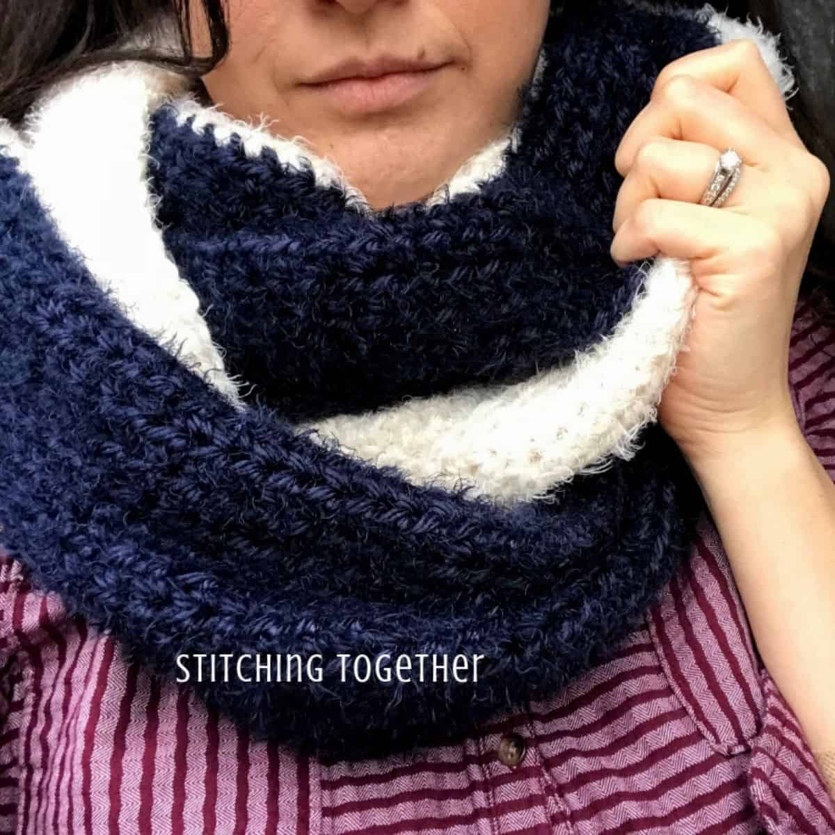 blue and white crochet scarf on a woman