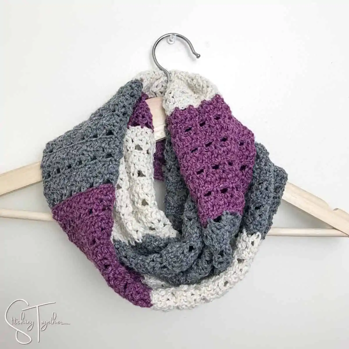 striped crochet scarf on a hanger