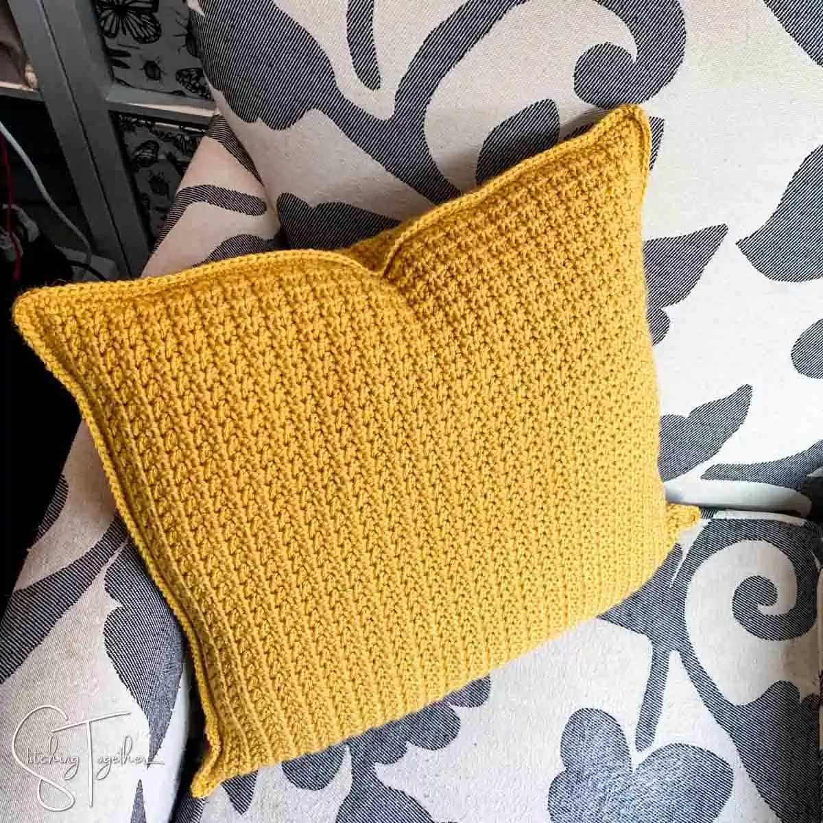 yellow crochet cushion on a chair