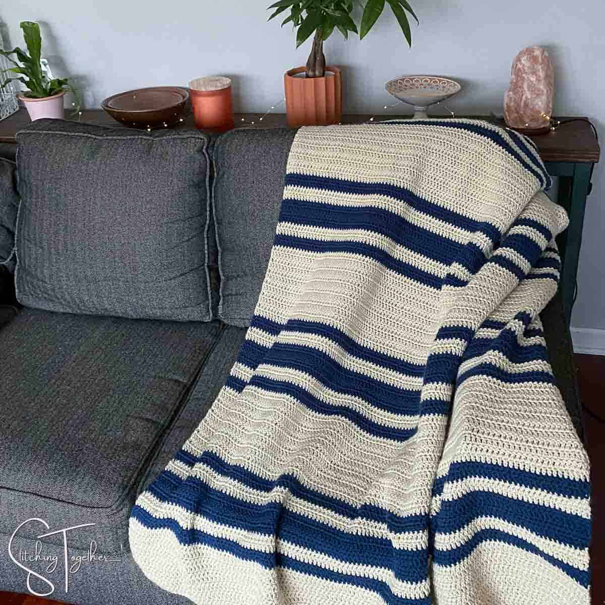 striped double crochet afghan draped on a couch