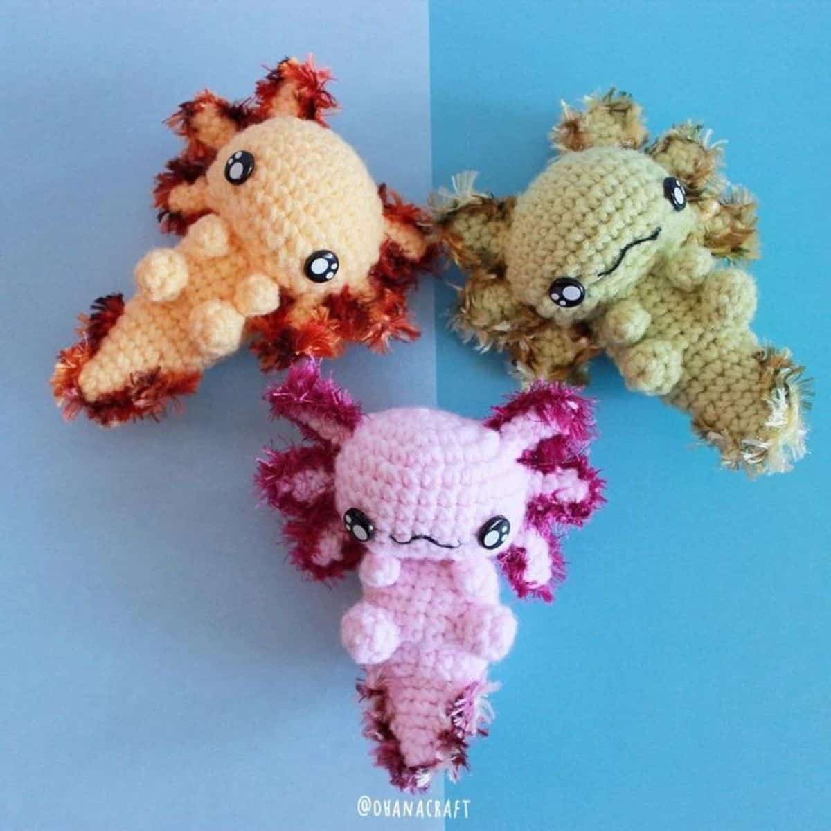 three axolotl crochet toys laying flat
