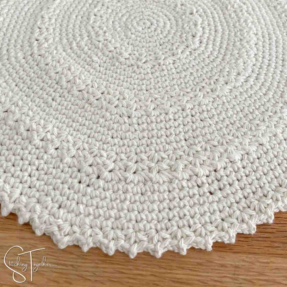 close up of a textured round crochet placemat