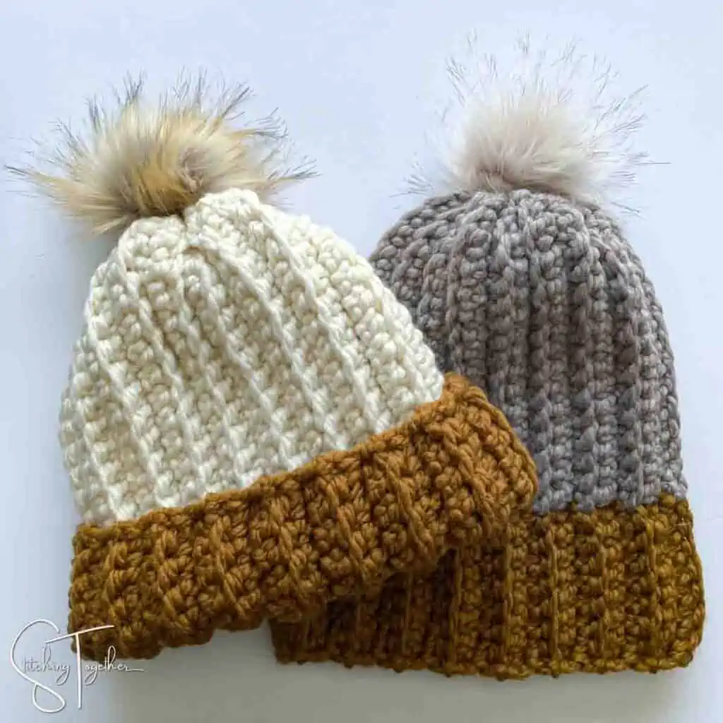 2 bulky crochet hats with pom pomslaying flat
