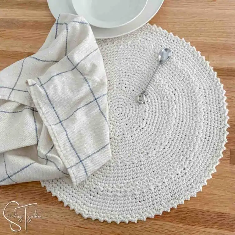 placemat, small spoon, white bowl and a kitchen towel