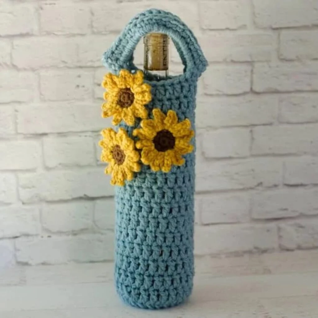 crochet wine cozy with sunflower embellishments