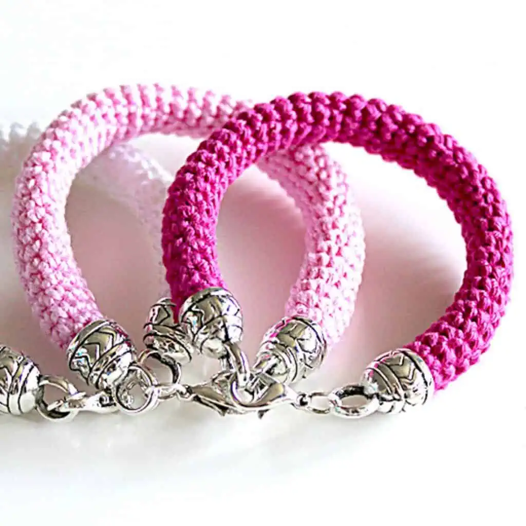 3 crochet bracelets laying on top of each pther