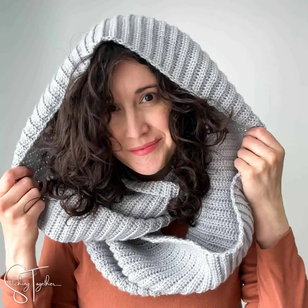 woman wearing a crochet infinity scarf as a hood