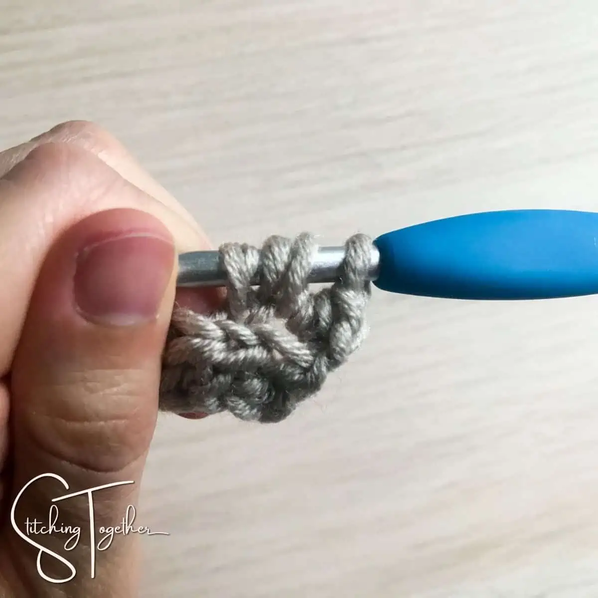 crochet stitch in process on a crochet hook