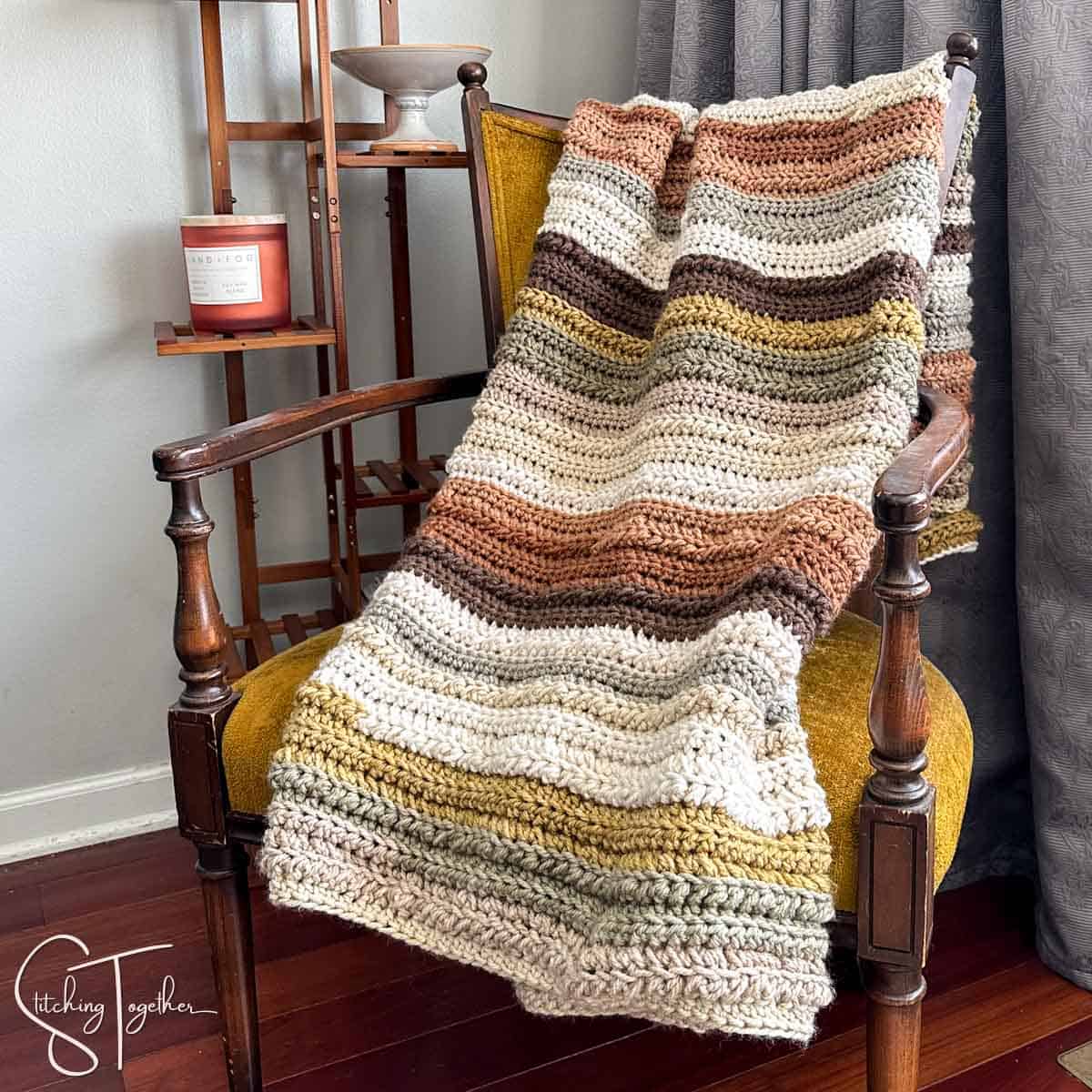 striped crochet blanket draped on a chair