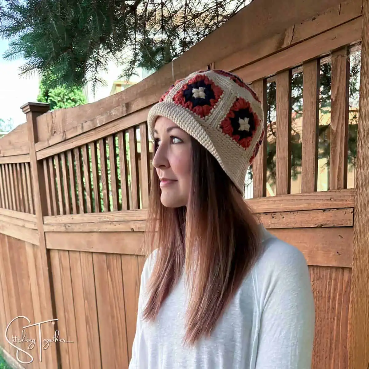 woman wearing a crochet granny square bucket hat viewed from the side