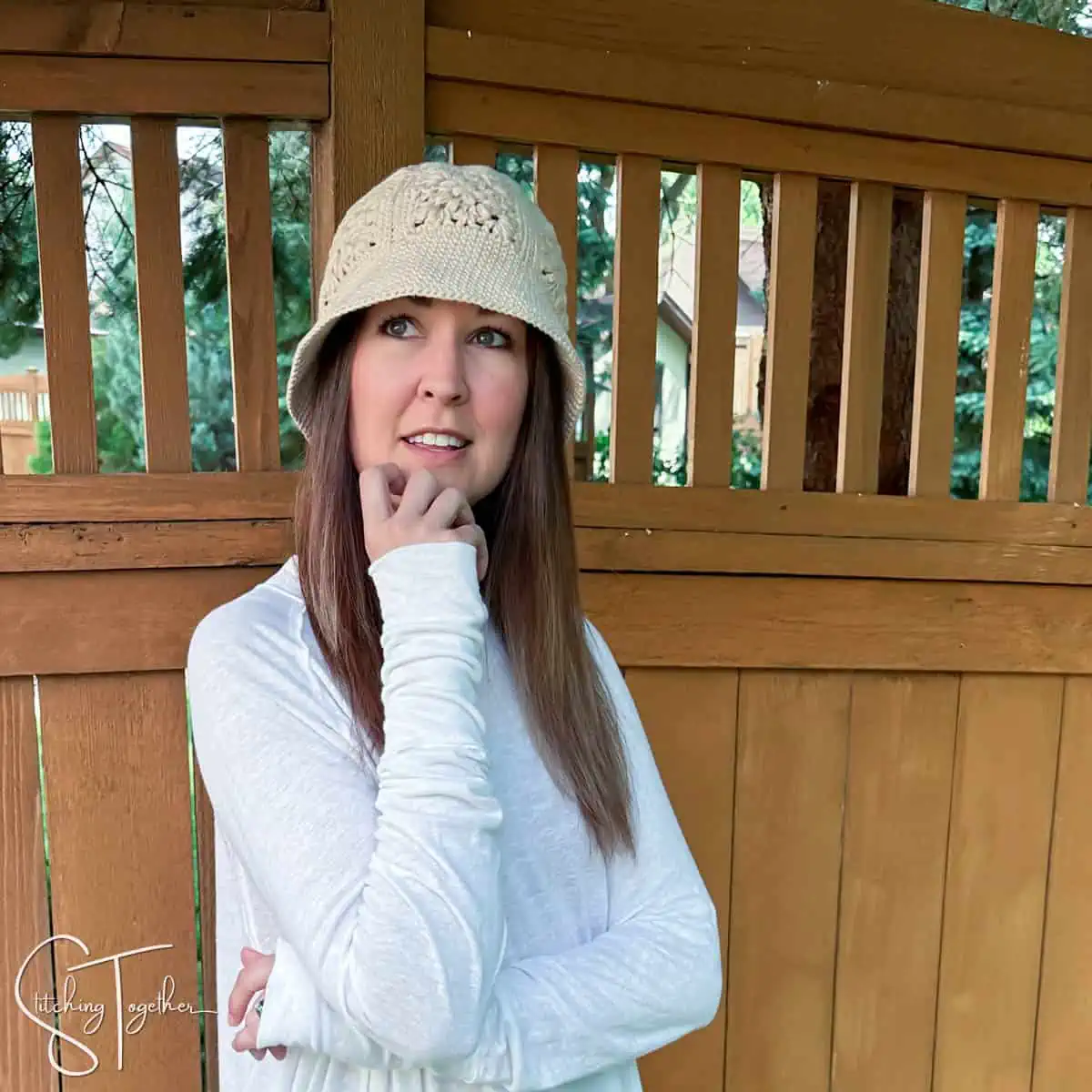 woman wearing a single color granny square bucket hat