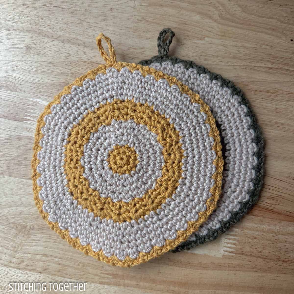 two round crochet trivets one stacked on top of the other