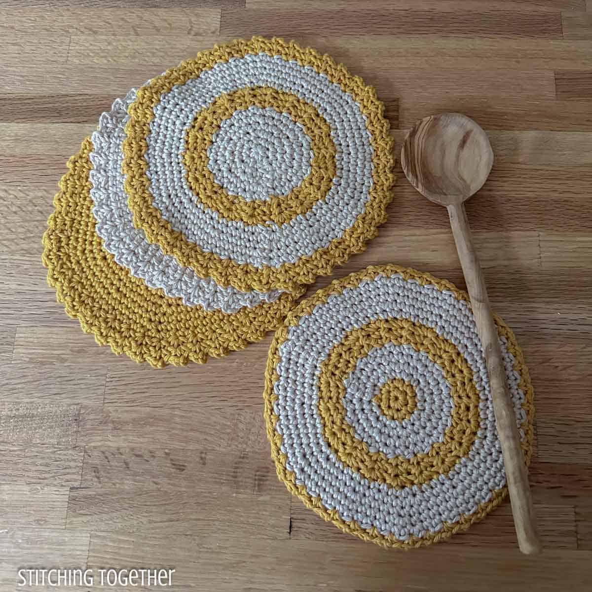 crochet round trivet and round dishcloths with a wooden spoon