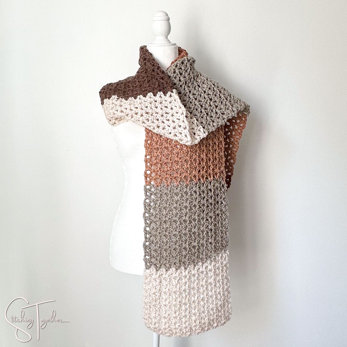 multicolored v stitch crochet scarf wrapped on a headless mannequin