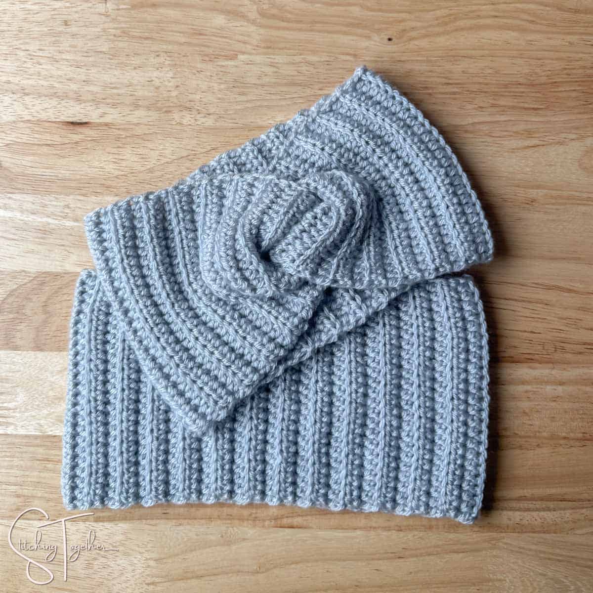 a crochet twisted headband and a ribbed headband laying flat
