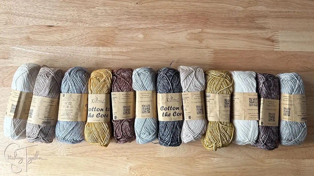 12 yarn skeins laying next to each other