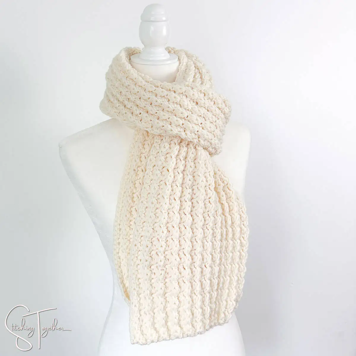 ivory textured crochet scarf wrapped on a headless mannequin