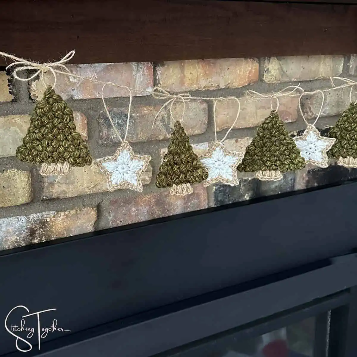 close up of a a crochet Christmas tree garland with stars hanging on a decorated mantle