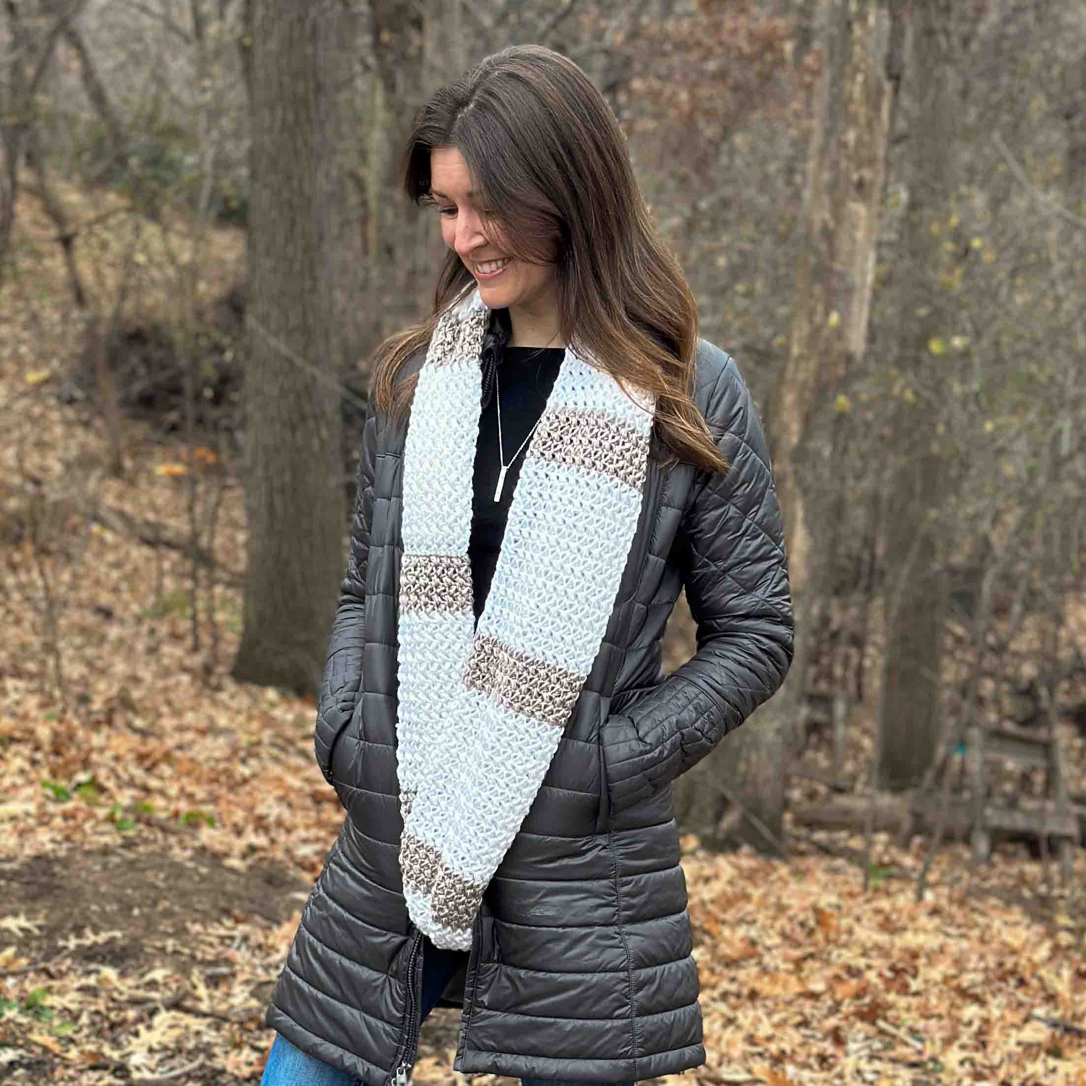 woman outside wearing an unlooped striped crochet infinity scarf
