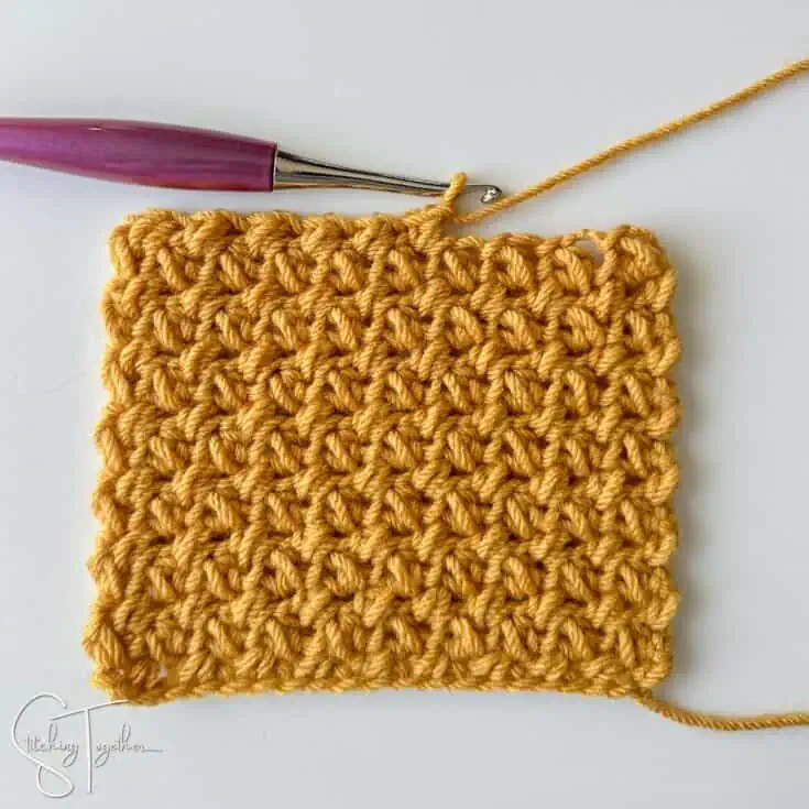 crochet swatch of the mini bean stitch being worked