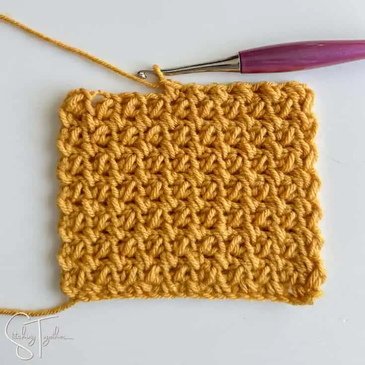 crochet swatch of the mini bean stitch being worked