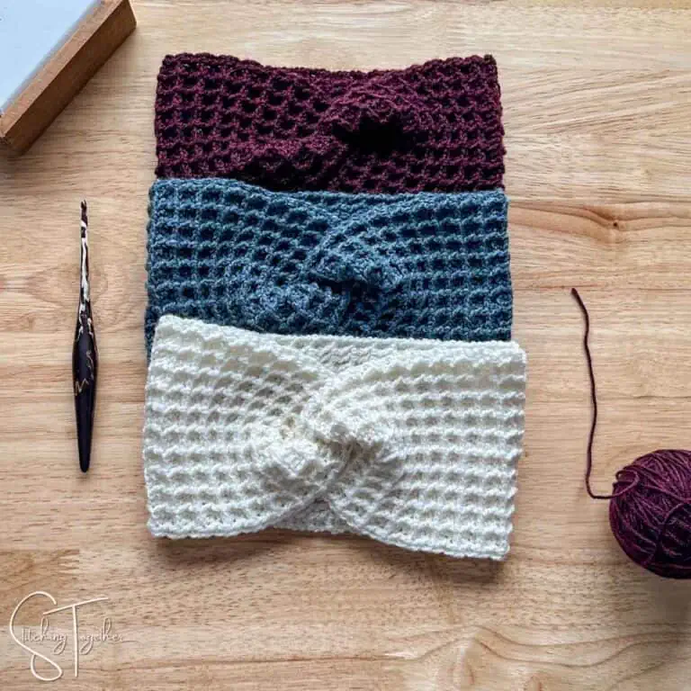 three crochet waffle stitch headbands, yarn ball, and a crochet hook