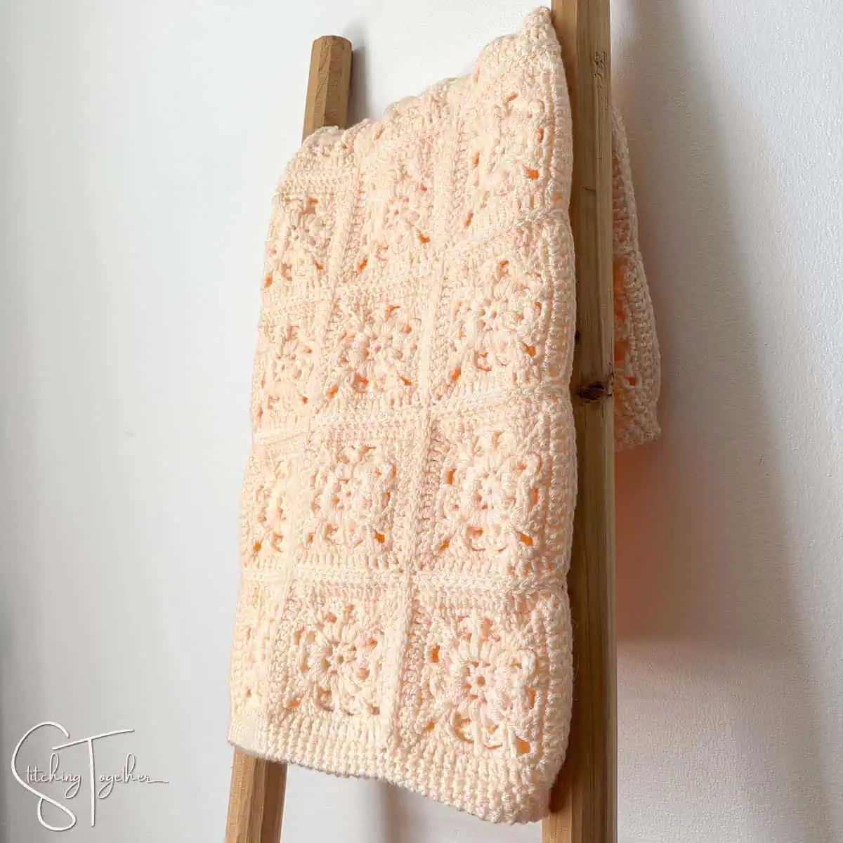 flower granny square baby afghan folder on blanket ladder