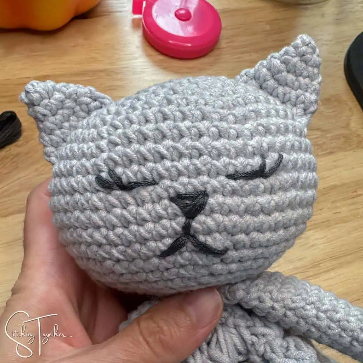 close up of crochet cat embroidered face