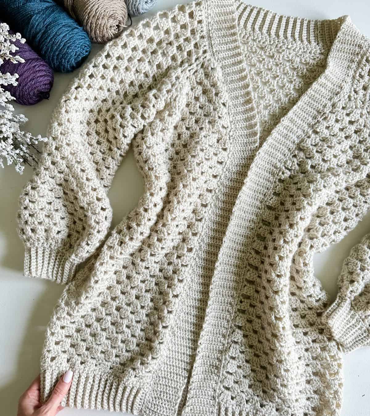 crochet cardigan laying on a flat surface