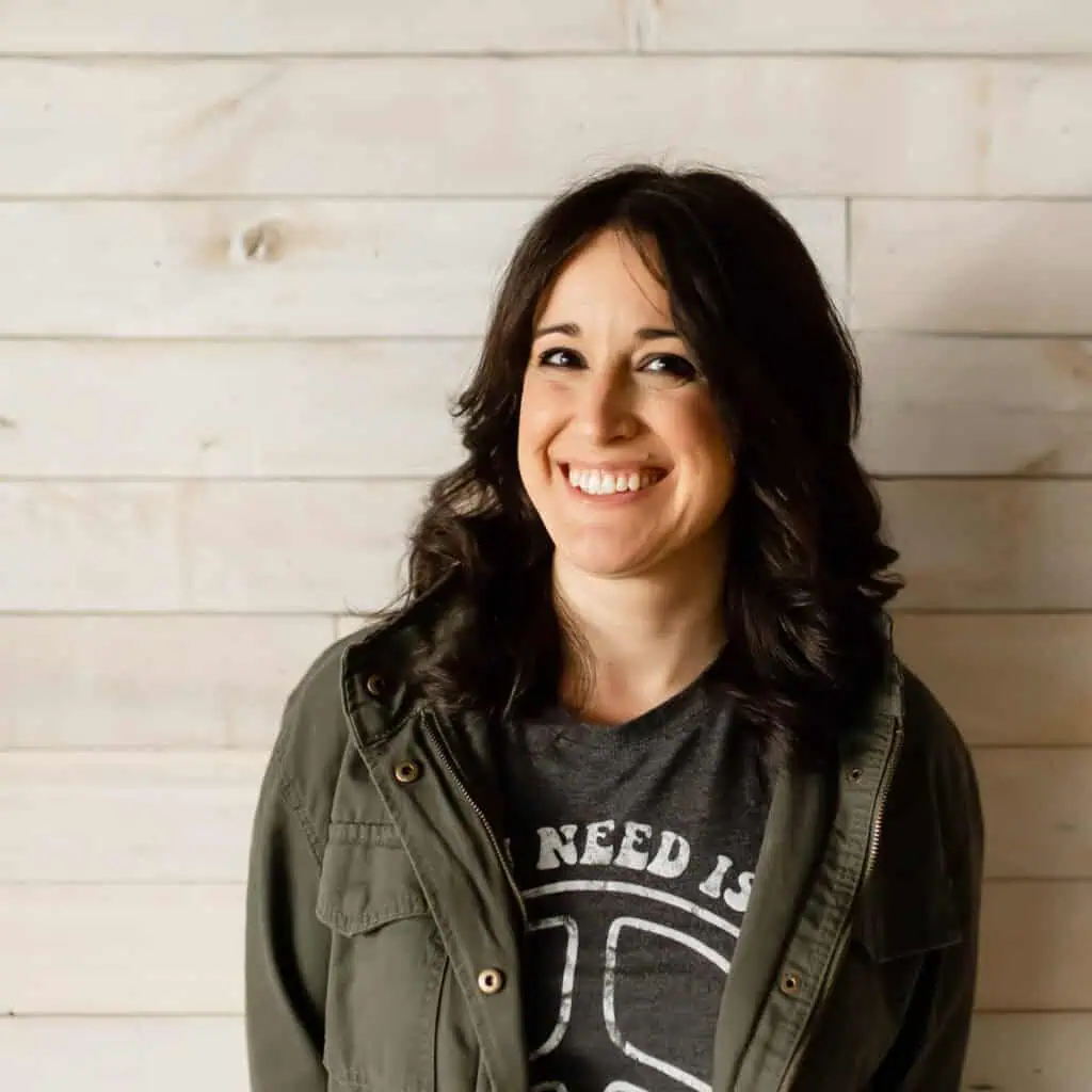 Jess from Stitching Together wearing a green jacket and smiling