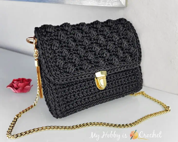 black crocheted purse with gold accents