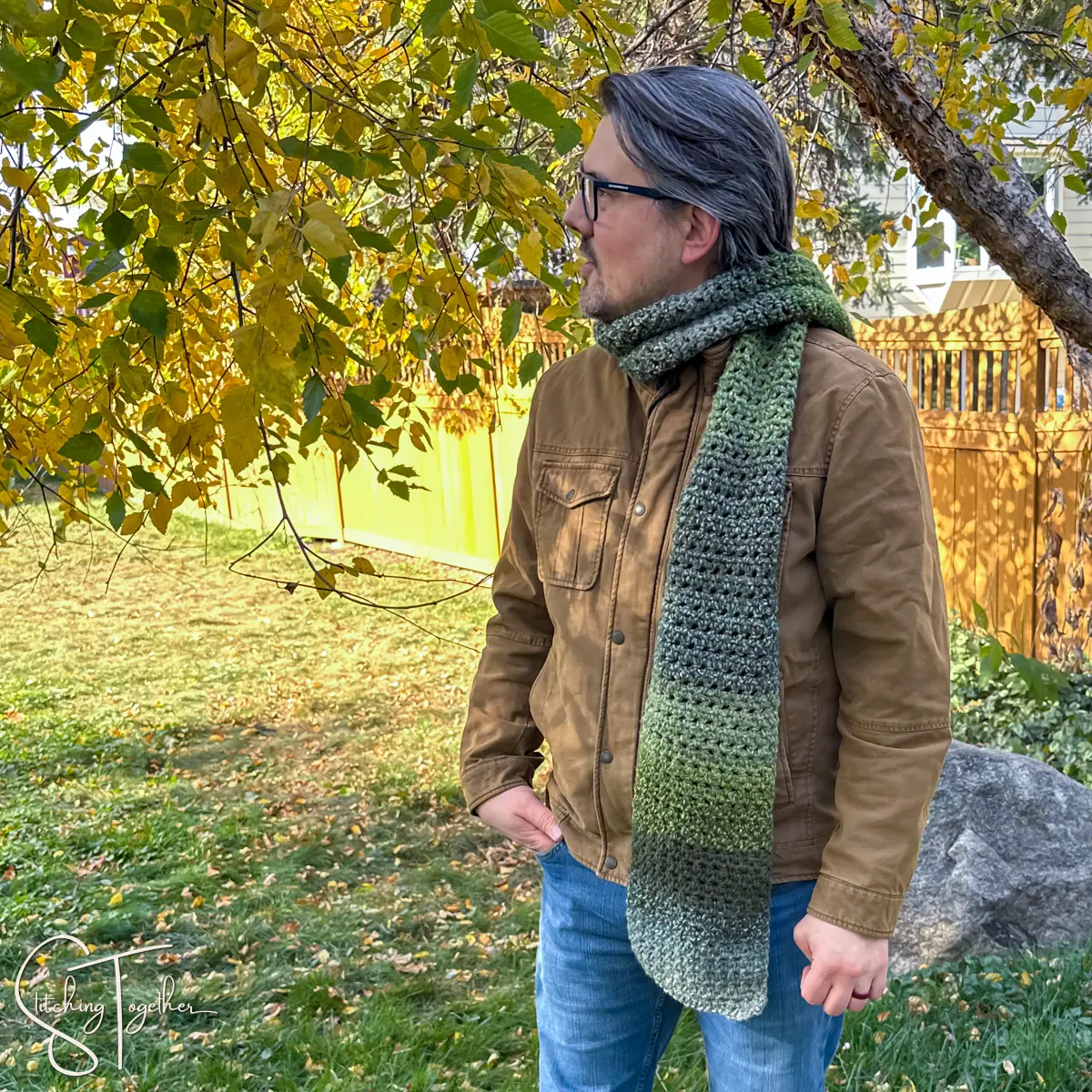 man wearing a green crochet scarf