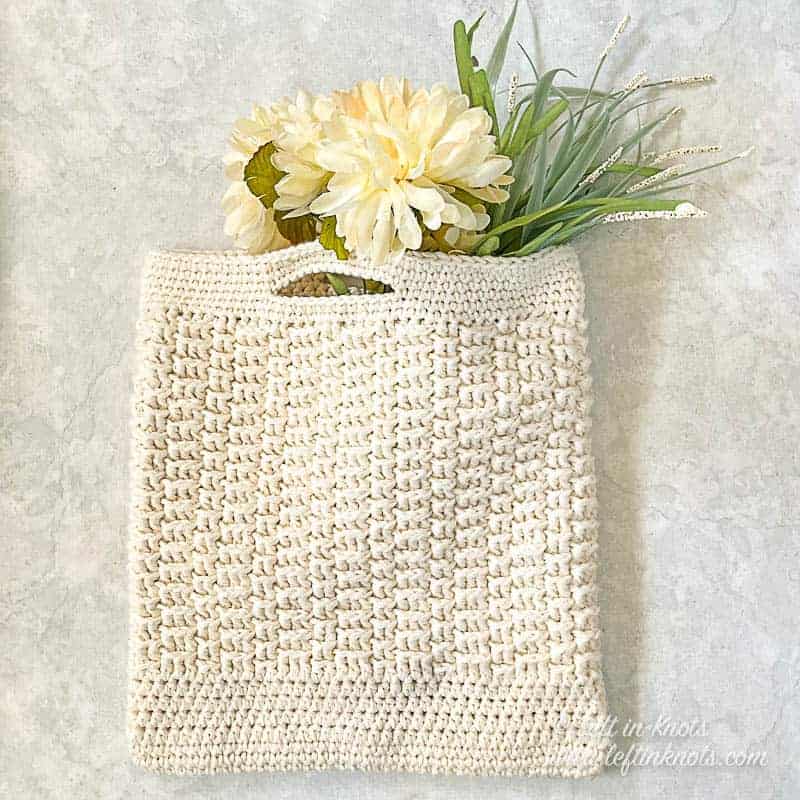 textured crochet bag with flowers sticking out
