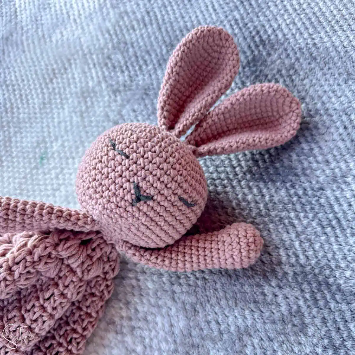 close up of pink bunny lovey that's crocheted