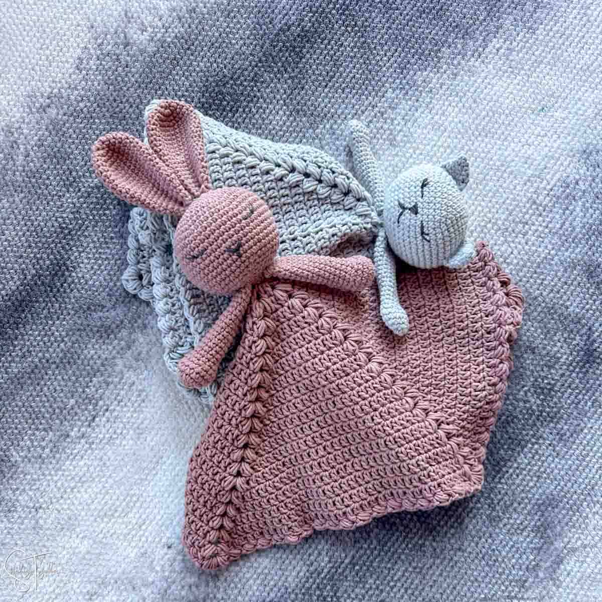 crochet bunny and kitty lovies laying on each other