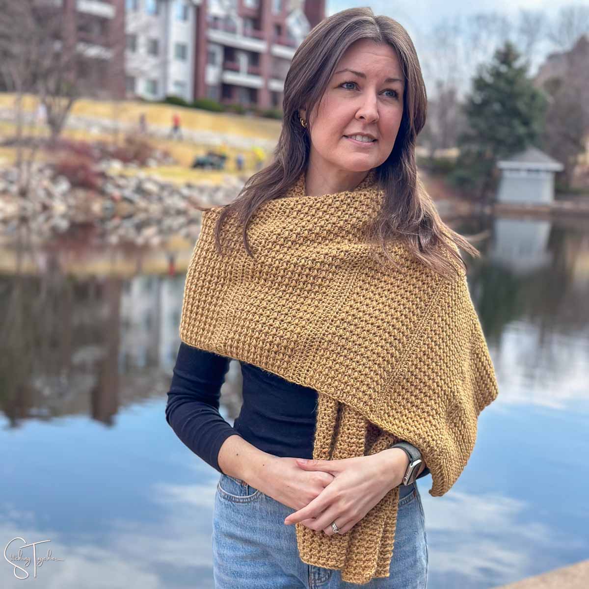 textured crochet shawl draped across a woman's shoulders