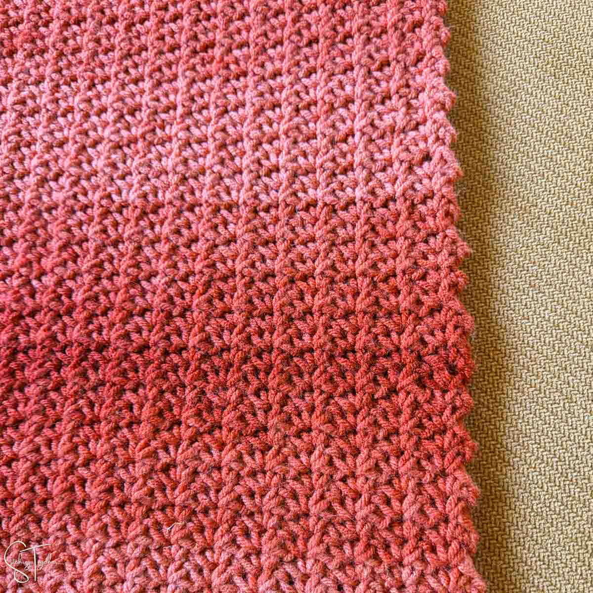 close up of textured crochet stitches at the edge of a blanket
